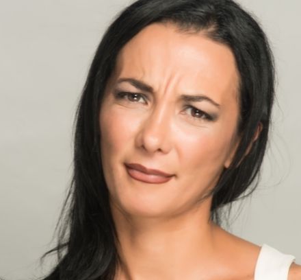 Brunette woman portraying disappointment - for dental crowns that are too big