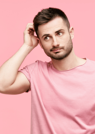 Man scratching his head in uncertainty about whether he will experience nerve damage after tooth removal